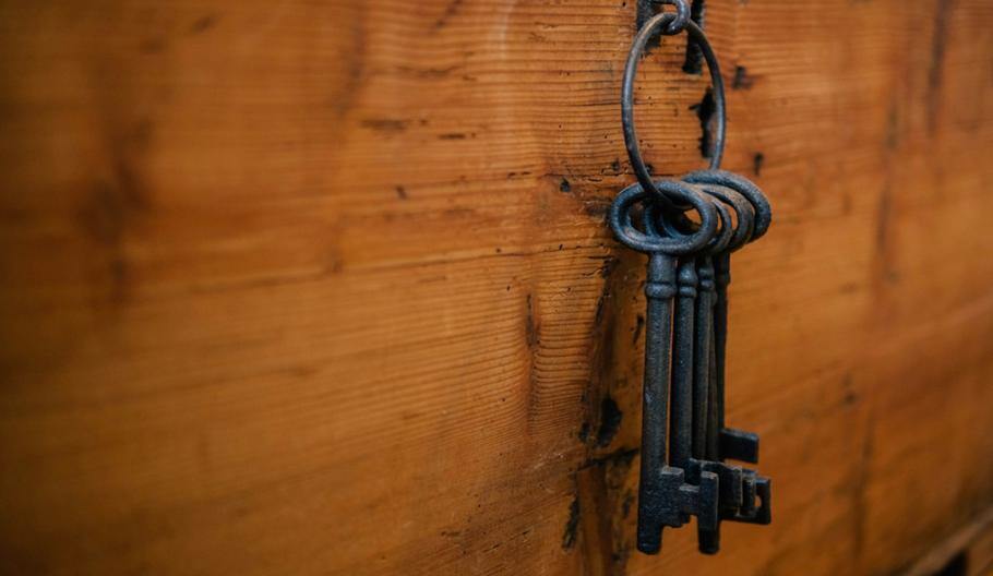 Set of keys hanging from a wooden wall